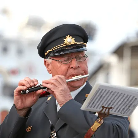 man in uniform playing the piccolo