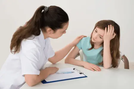 a social worker sitting next to a woman