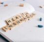 Health insurance spelled with wooden blocks to symbolize the difference between Aflac and MetLife insurance for alcohol addiction treatment